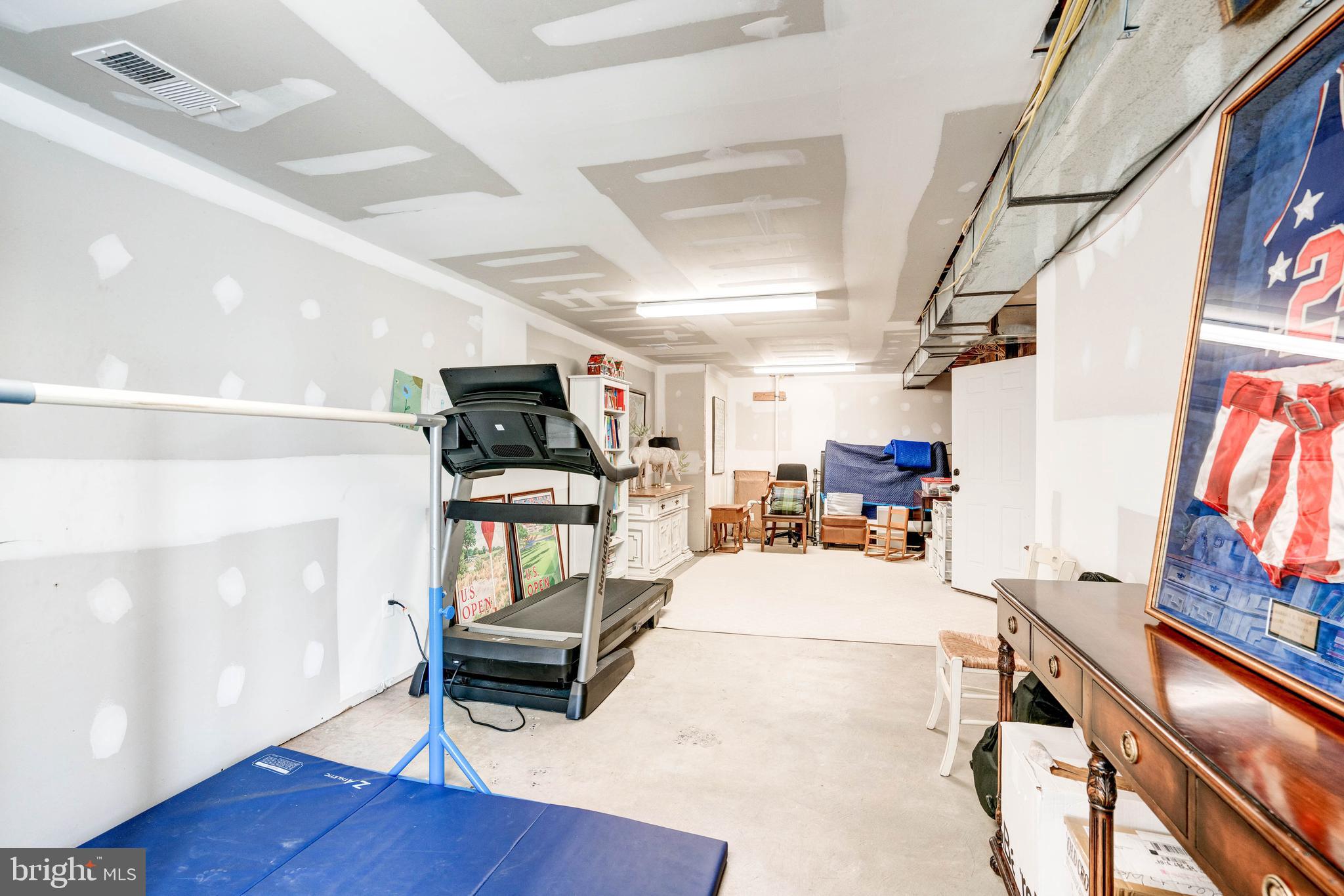 4509 Wetherill Road Bethesda, MD 20816 - Photo 75 of 89 a living room with furniture and a flat screen tv