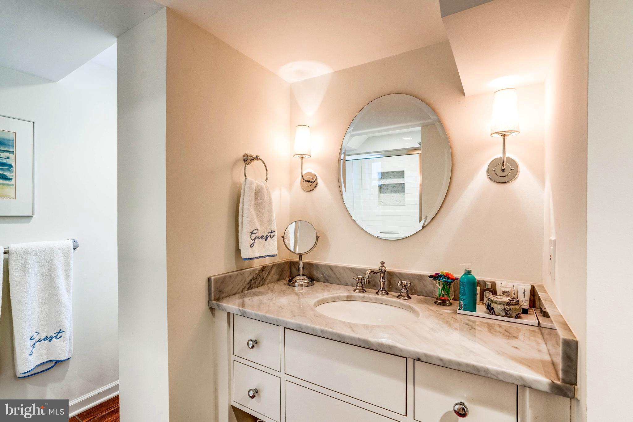 4509 Wetherill Road Bethesda, MD 20816 - Photo 79 of 89 a bathroom with a granite countertop sink and a mirror