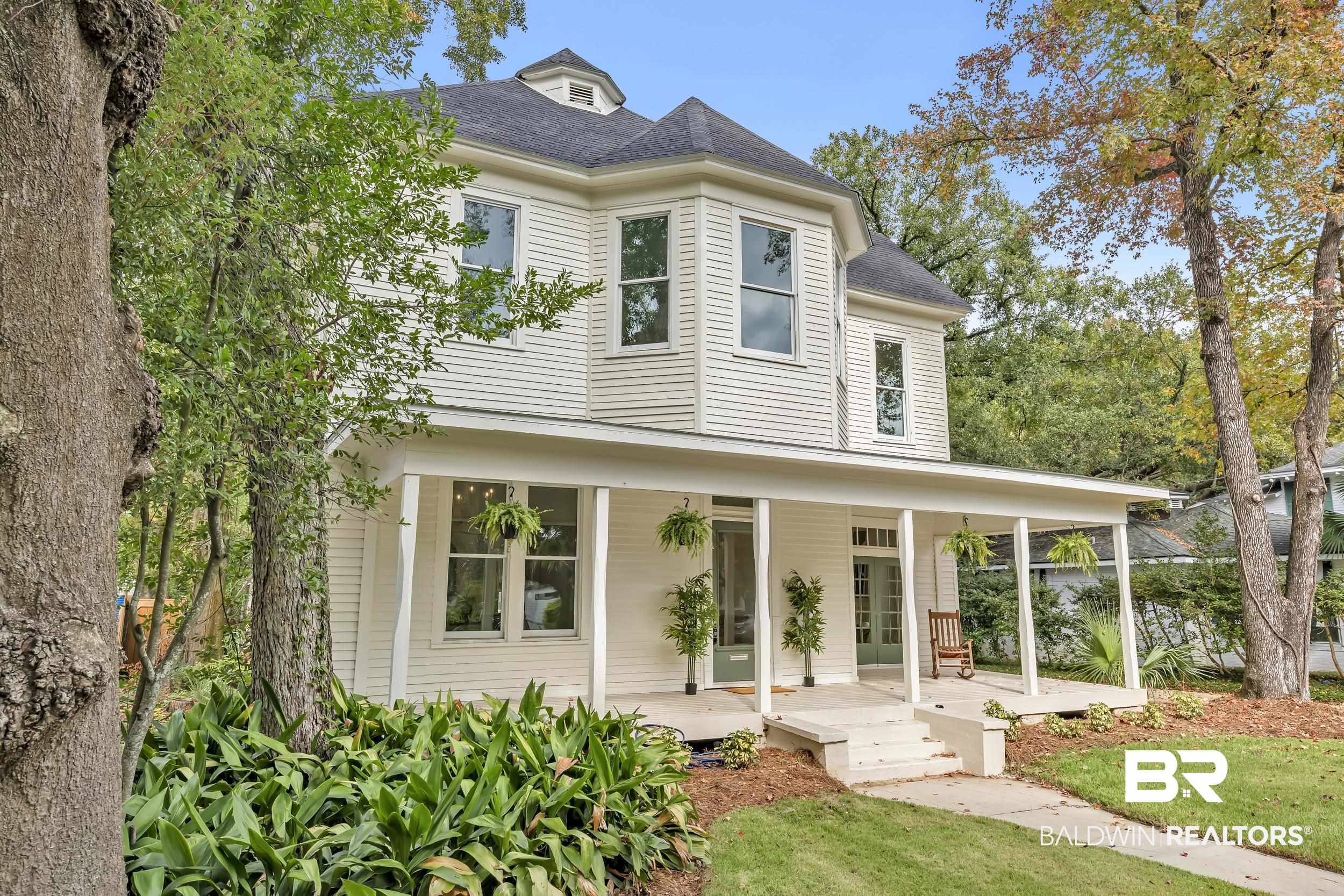 1662 Government Street Mobile, AL 36604 - Photo 2 of 33 View of front of house with roof with shingles, a porch, and a front lawn