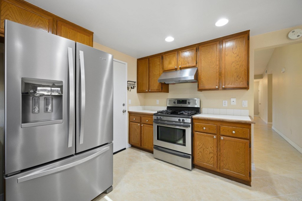 228 Ocotillo Place Oceanside, CA 92057 - Photo 14 of 31 a kitchen with stainless steel appliances granite countertop a refrigerator stove and sink