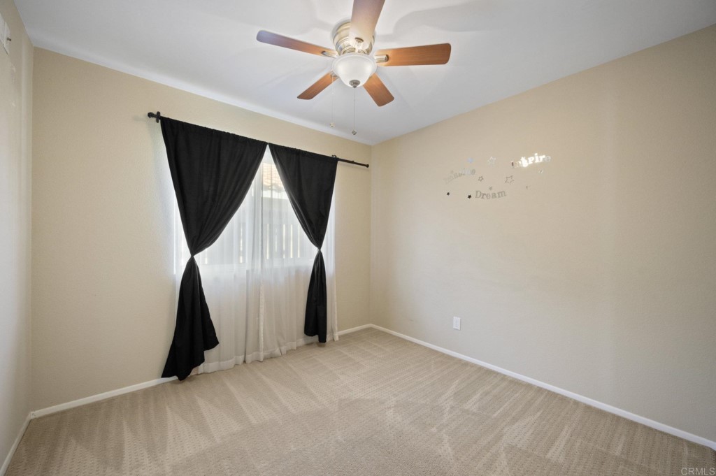 228 Ocotillo Place Oceanside, CA 92057 - Photo 15 of 31 an empty room with wooden floor and ceiling fan