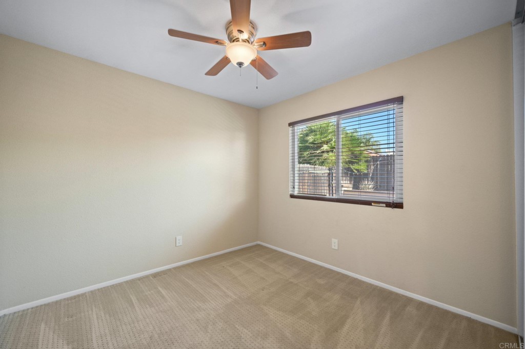 228 Ocotillo Place Oceanside, CA 92057 - Photo 17 of 31 an empty room with windows and ceiling fan