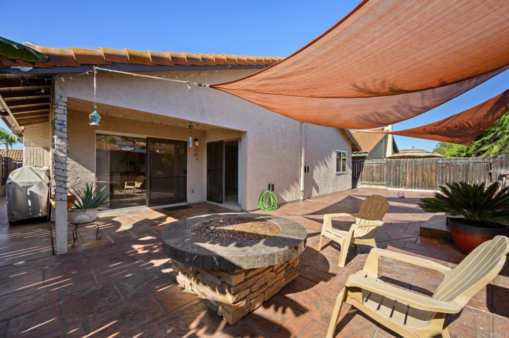 228 Ocotillo Place Oceanside, CA 92057 - Photo 22 of 31 a patio with a table and chairs and potted plants
