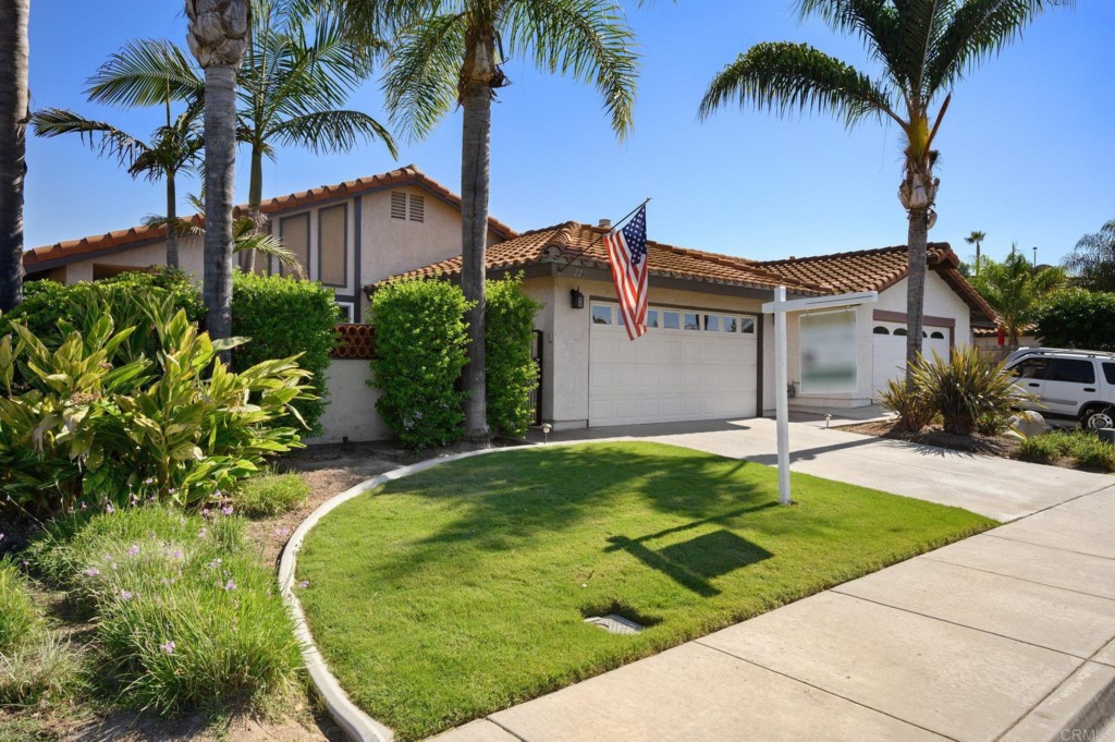 228 Ocotillo Place Oceanside, CA 92057 - Photo 31 of 31 a house with palm tree next to a yard