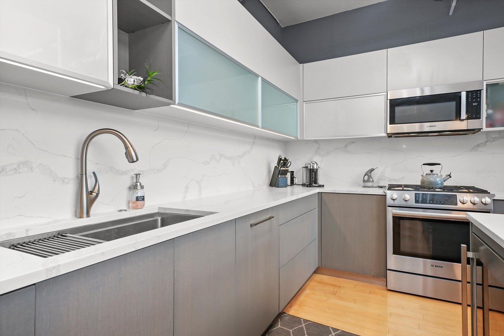 1530 South State Street, Unit 1004 Chicago, IL 60605 - Photo 13 of 38 a kitchen with stainless steel appliances granite countertop a sink a stove and microwave