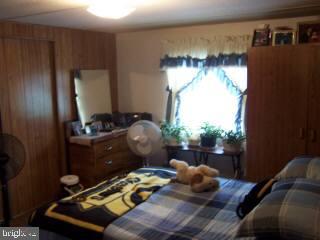 6525 Morris Road Pittsville, MD 21850 - Photo 6 of 8 a bed room with furniture and a window