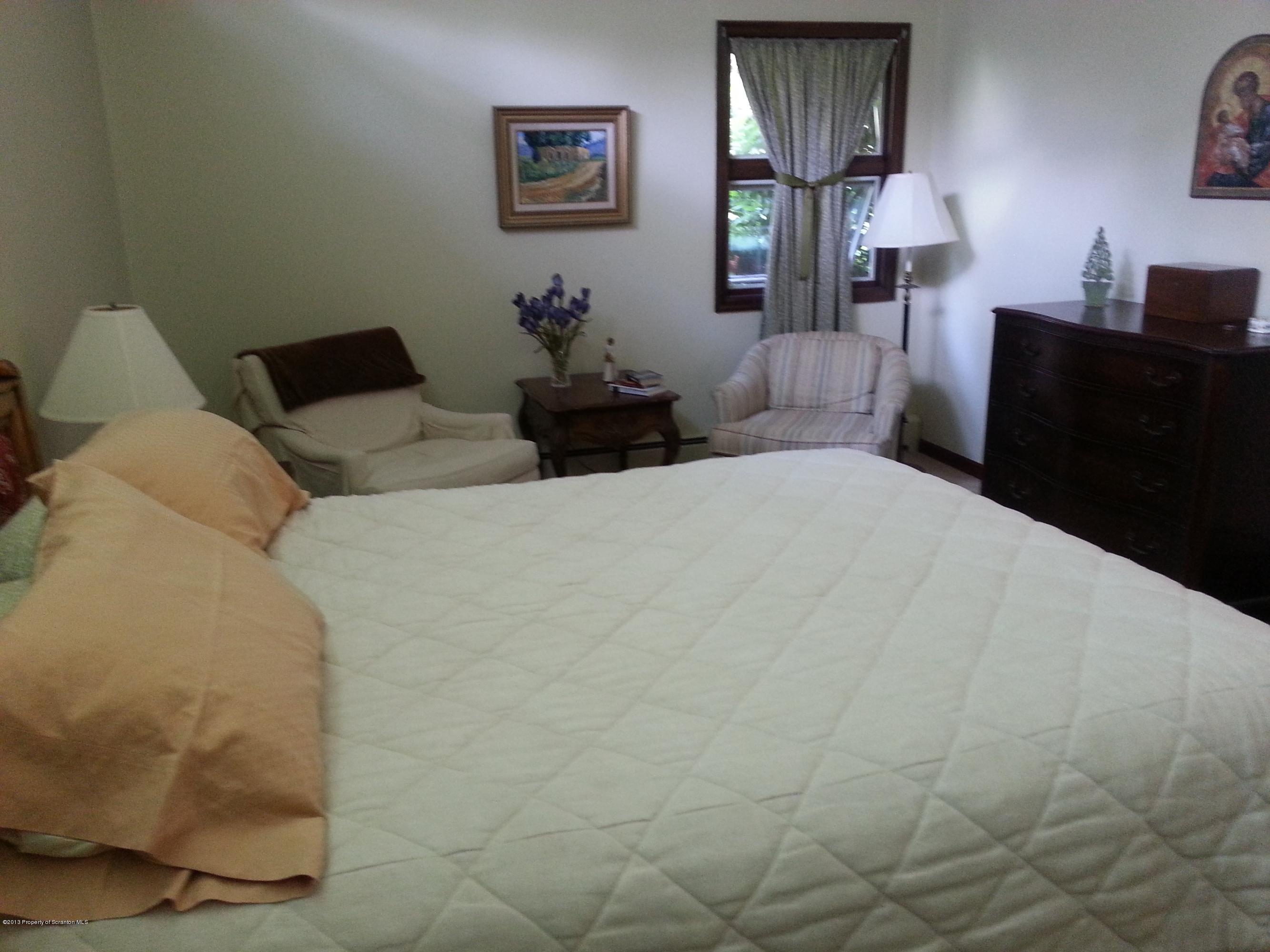 1091 Reservoir Road Moscow, PA 18444 - Photo 54 of 71 a bedroom with a bed and wooden floor