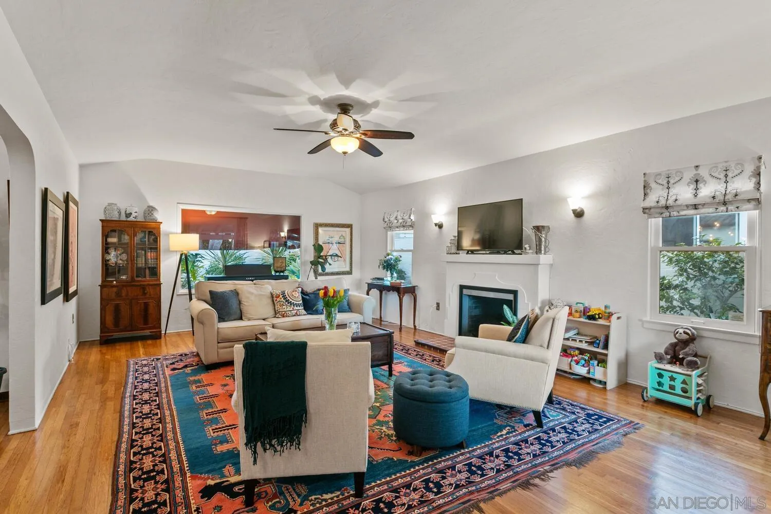 a living room with fireplace furniture and a flat screen tv