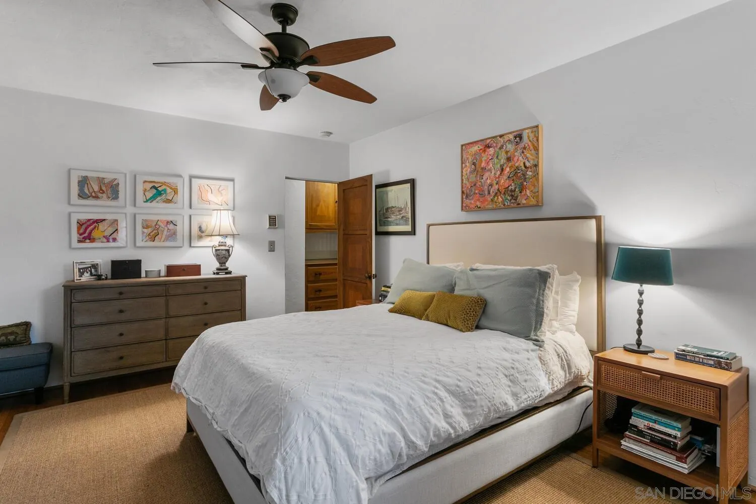 3443 Freeman Street San Diego, CA 92106 - Photo 11 of 35 a bedroom with a bed and a chandelier