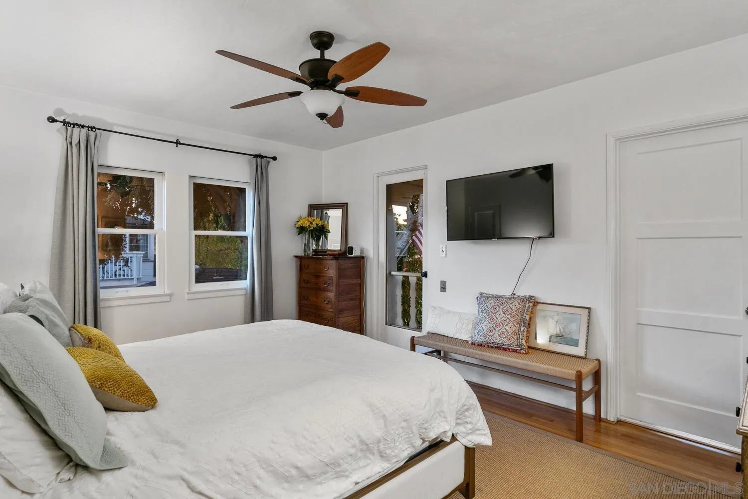 3443 Freeman Street San Diego, CA 92106 - Photo 13 of 35 a bedroom with a bed a flat screen tv and a chandelier