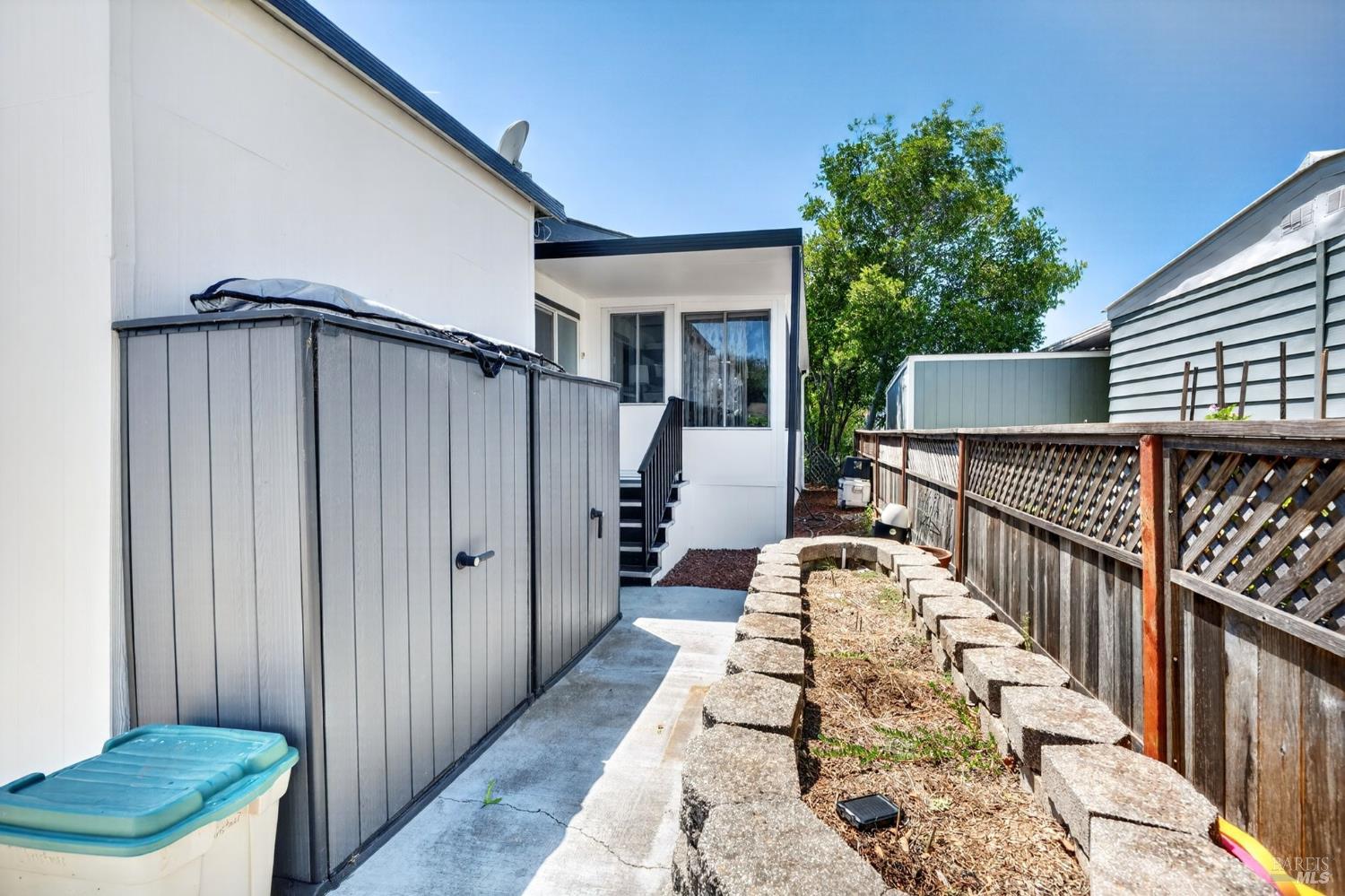 146 Stratford Way Santa Rosa, CA 95401 - Photo 30 of 39 Back yard with planter beds, and storage sheds