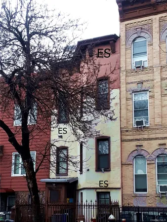 front view of a building with a tree