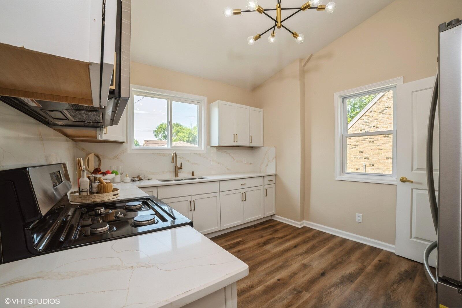 933 East 44th Place Gary, IN 46409 - Photo 11 of 28 a kitchen with a sink stove and microwave
