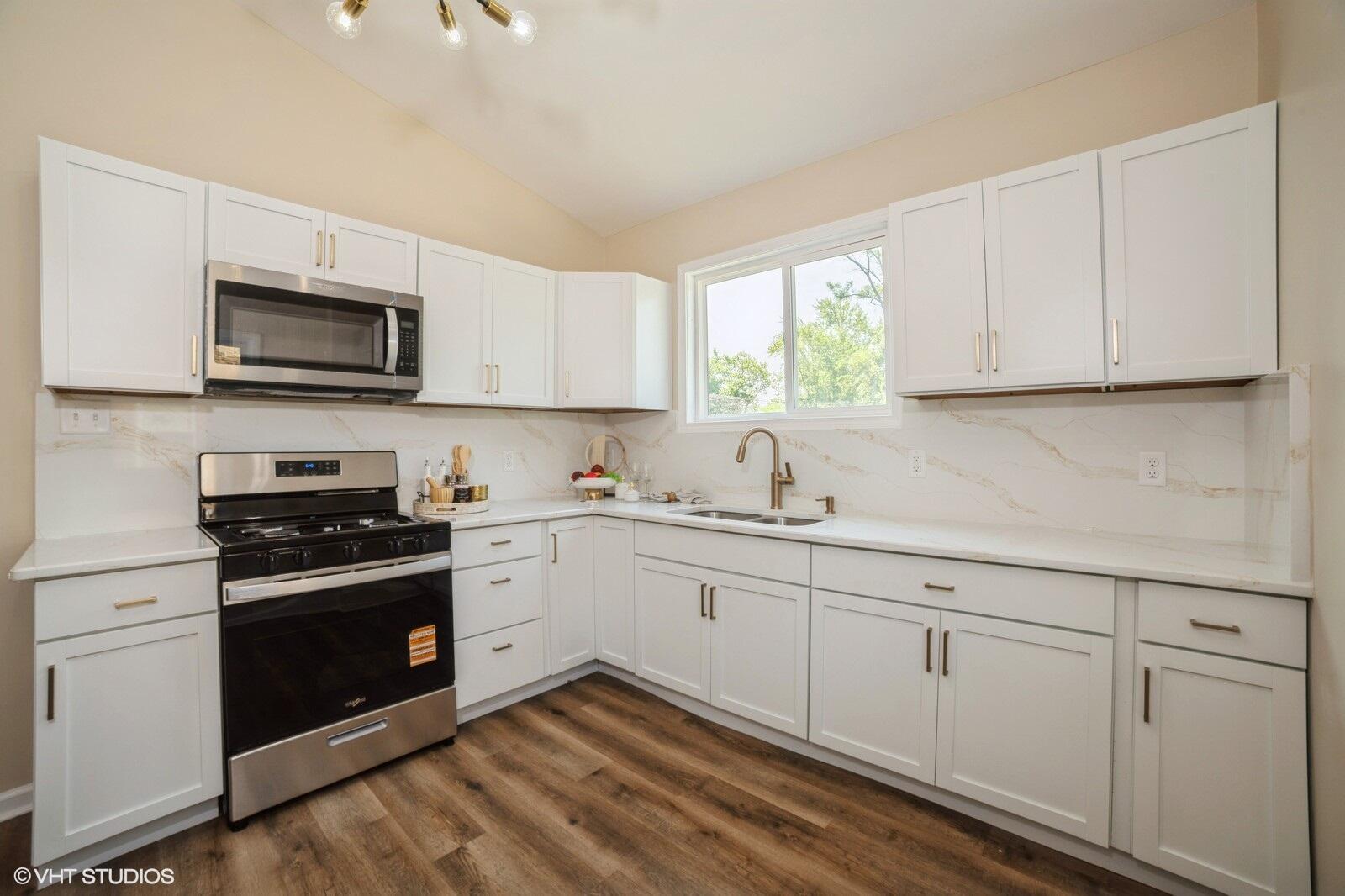 933 East 44th Place Gary, IN 46409 - Photo 12 of 28 a kitchen with sink cabinets and stainless steel appliances
