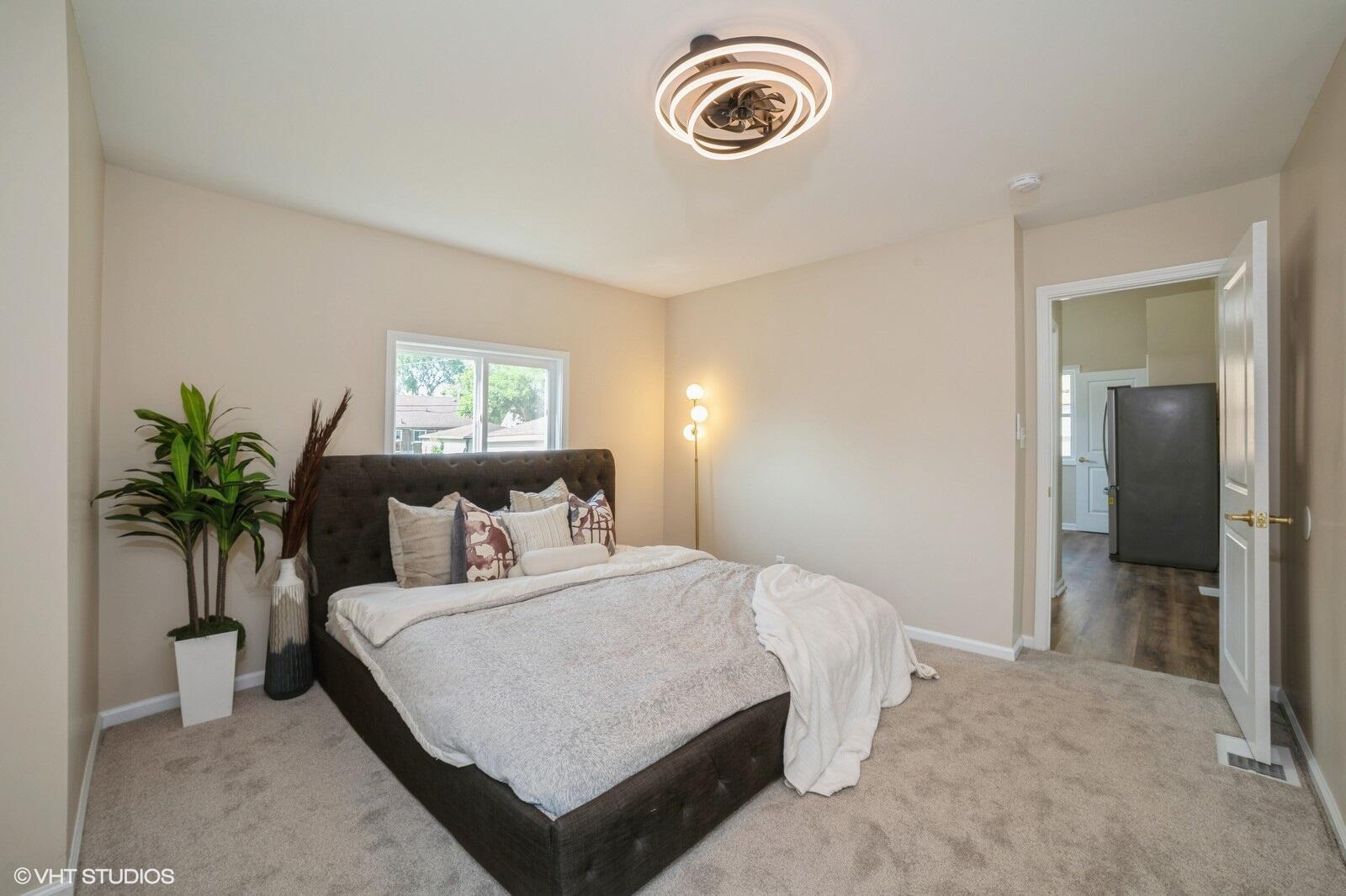 933 East 44th Place Gary, IN 46409 - Photo 9 of 28 a bedroom with a bed and a potted plant