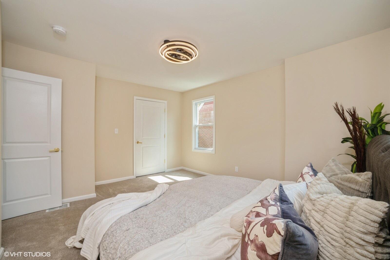 933 East 44th Place Gary, IN 46409 - Photo 10 of 28 a bedroom with a bed and a potted plant