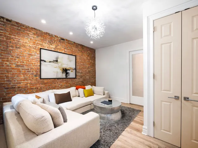 a living room with furniture and a chandelier