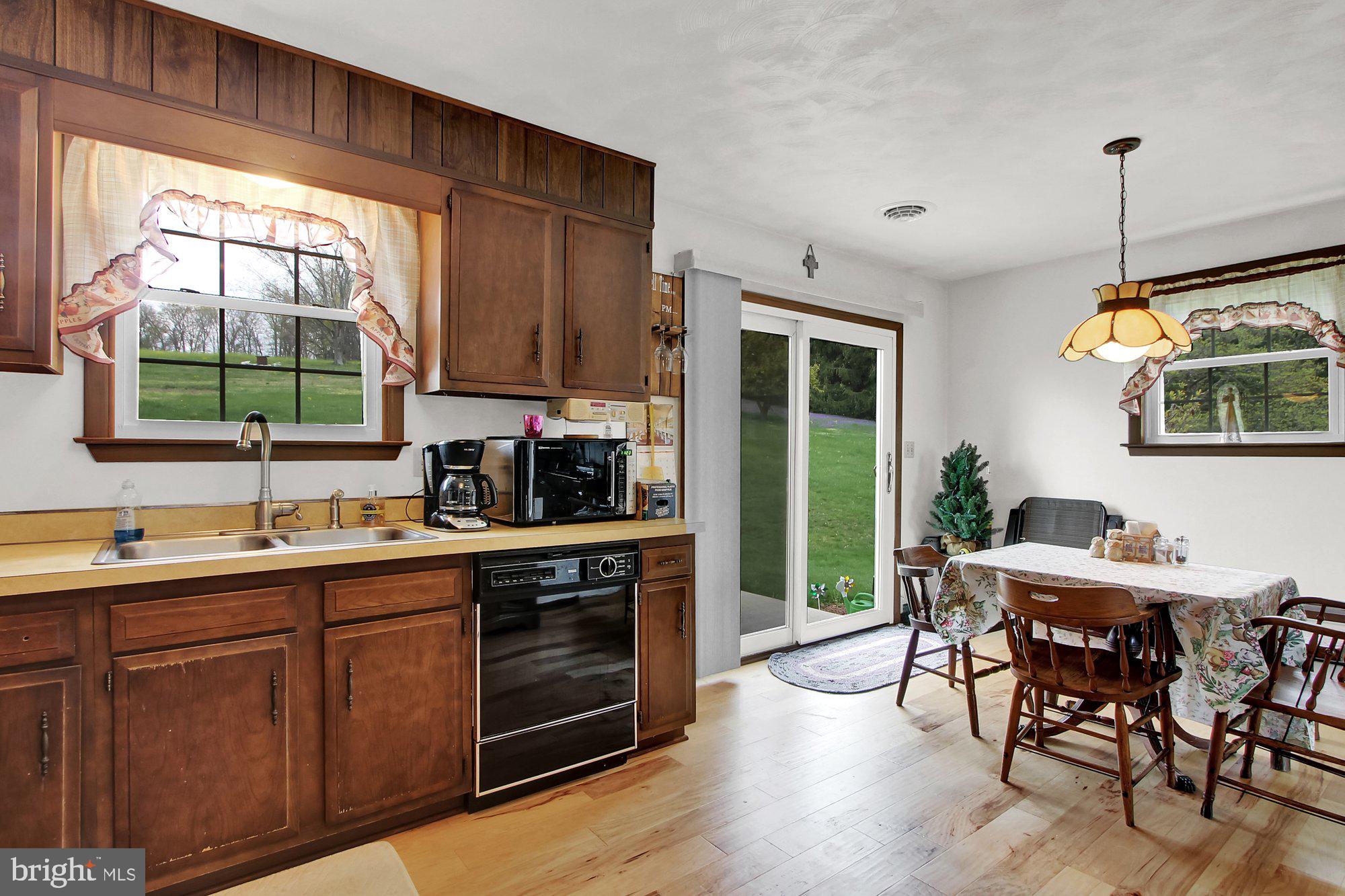 922 Hobart Road Hanover, PA 17331 - Photo 11 of 28 a kitchen with wooden cabinets a sink a stove and a window