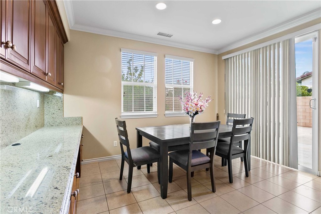 14496 Meadow Brook Eastvale, CA 92880 - Photo 13 of 33 a view of a dining room with furniture and chandelier