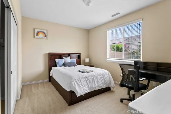 a bedroom with a bed and a table