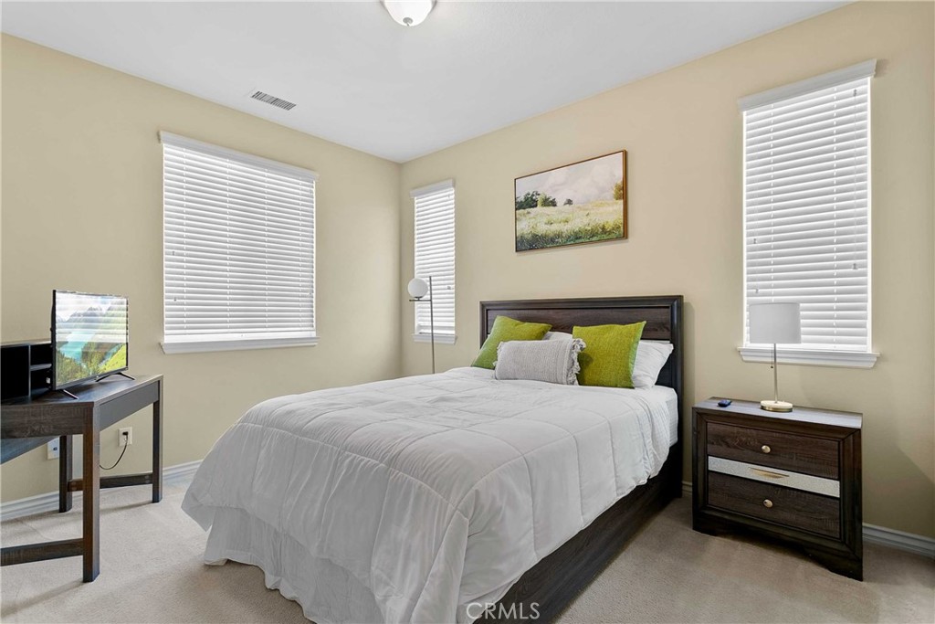 14496 Meadow Brook Eastvale, CA 92880 - Photo 18 of 33 a bedroom with a bed and a window