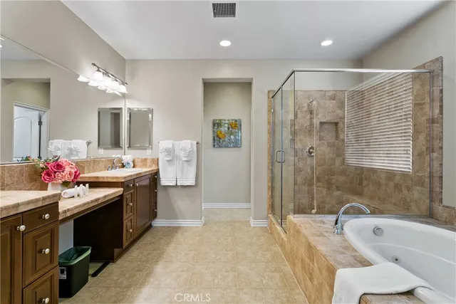 a spacious bathroom with a sink mirror and a bathtub