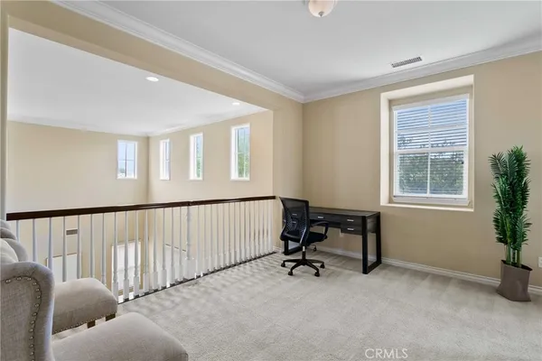a view of a livingroom with workspace and a window
