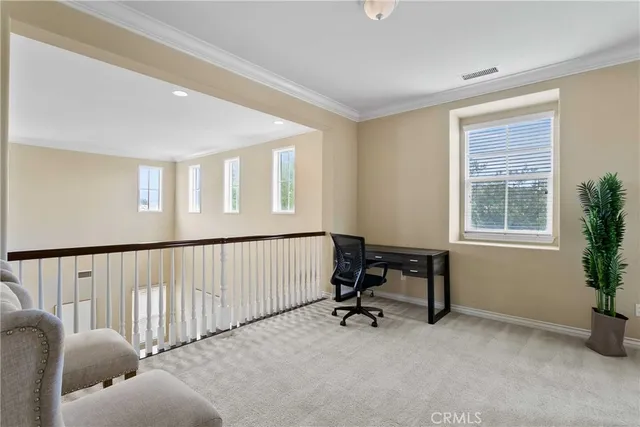 a view of a livingroom with workspace and a window