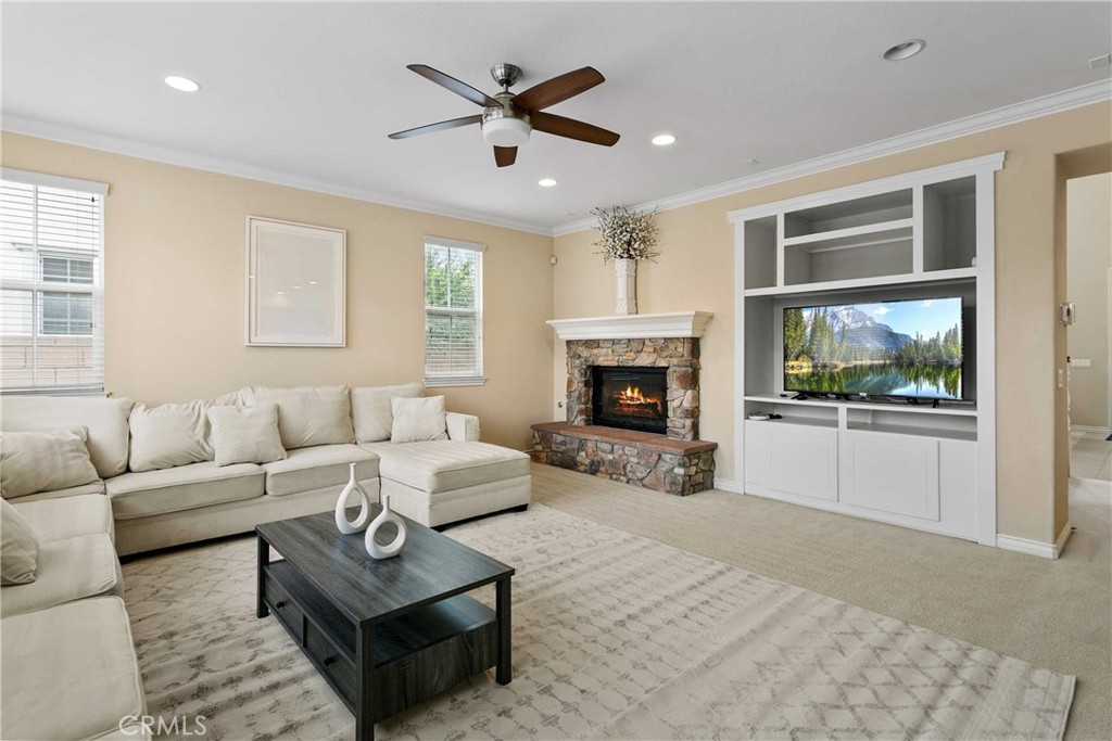 14496 Meadow Brook Eastvale, CA 92880 - Photo 3 of 33 a living room with furniture a window and a fireplace