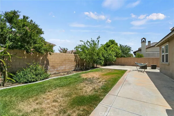 a view of a backyard with sitting area