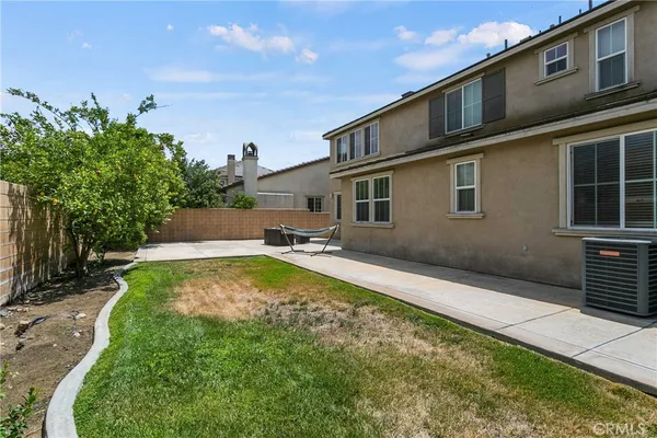 a swimming pool with outdoor seating and yard