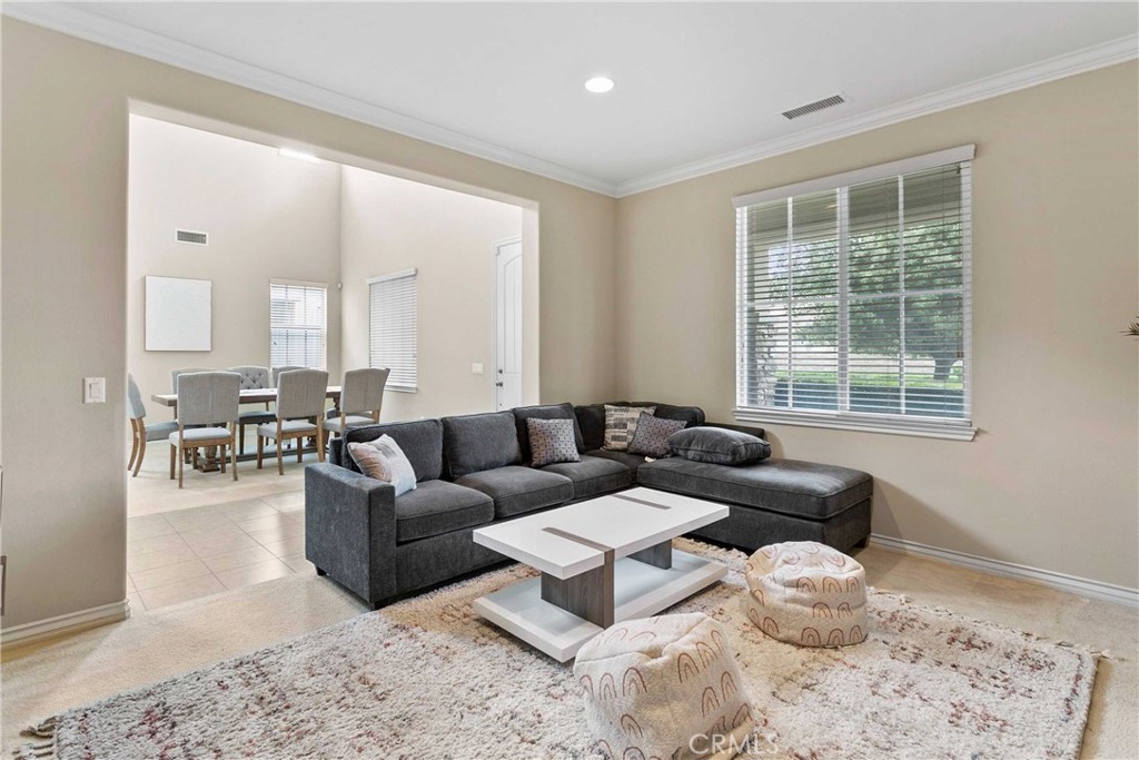 14496 Meadow Brook Eastvale, CA 92880 - Photo 6 of 33 a living room with furniture and a large window