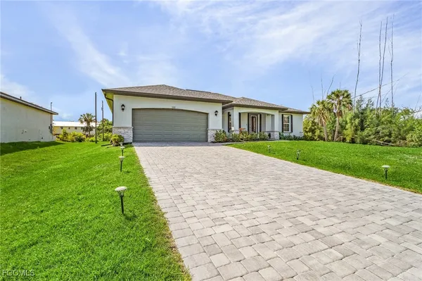 a front view of house with yard and green space