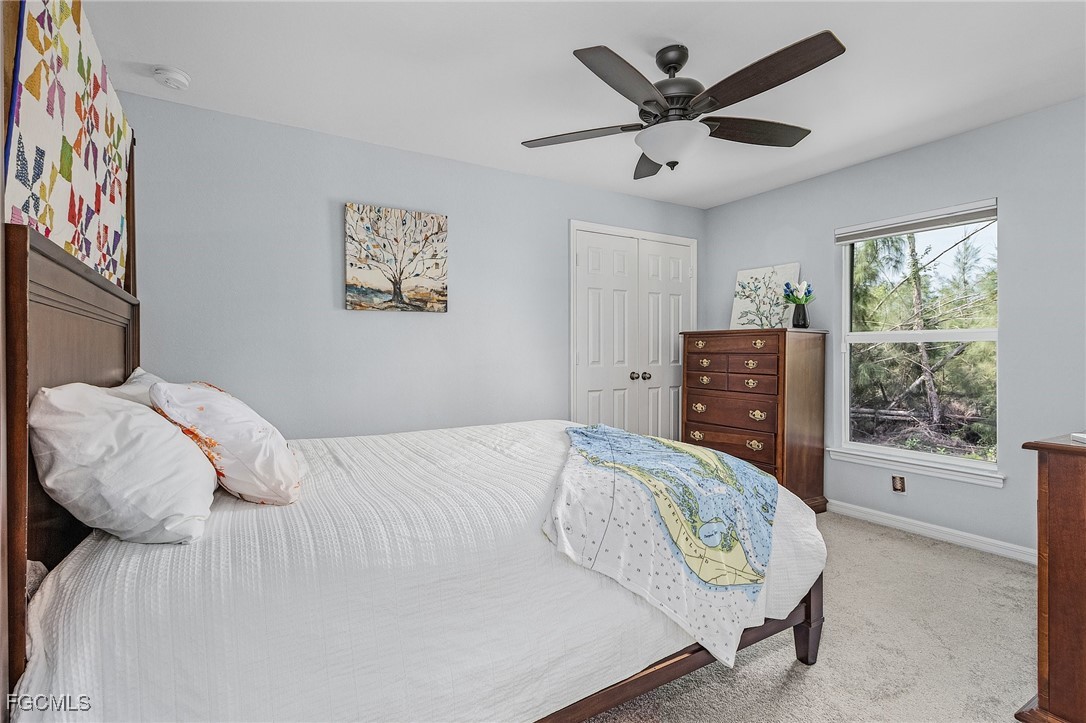 3505 Mango Street St. James City, FL 33956 - Photo 17 of 32 a bedroom with a bed and window