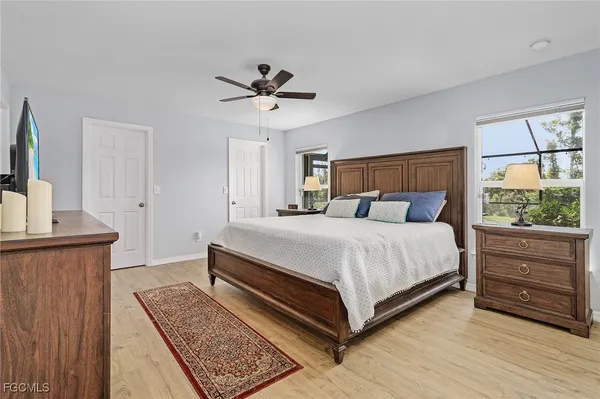 a bedroom with a bed a window and dresser