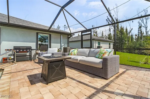 a living room with patio furniture and garden
