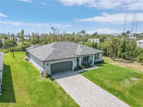 a aerial view of a house next to a yard