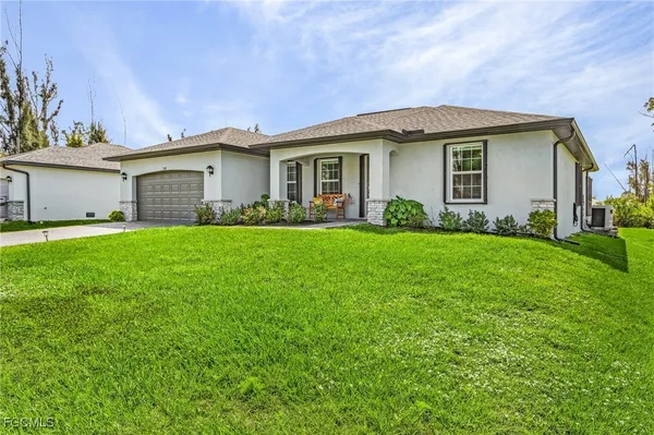 a front view of house with yard and green space