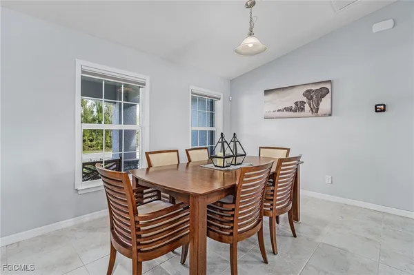 a dining room with furniture a rug and a window