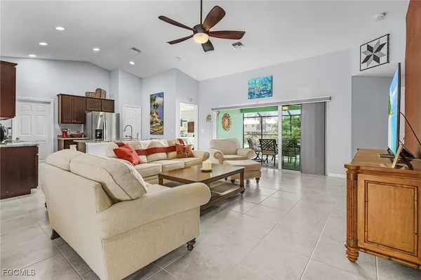 a living room with furniture a flat screen tv and a large window
