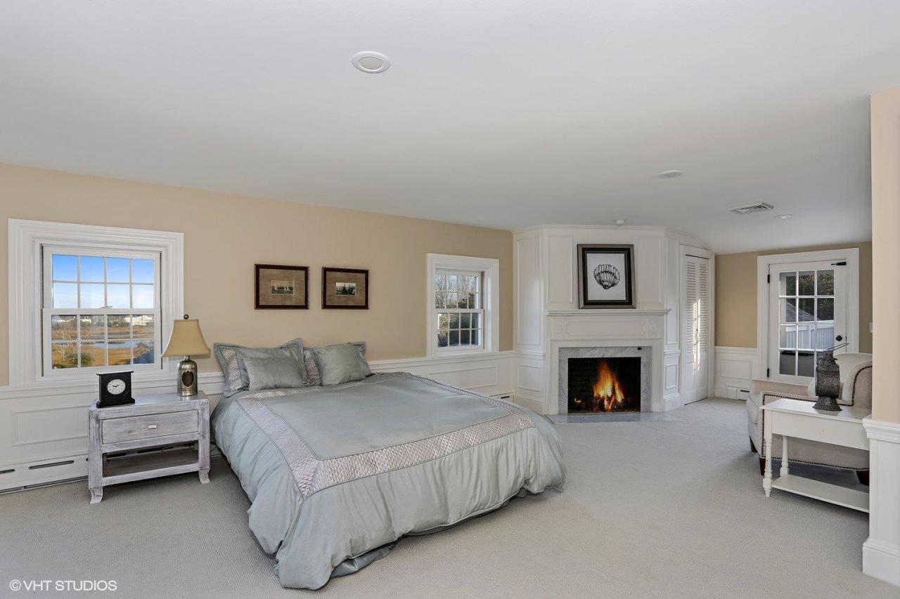 19 Salten Point Road Barnstable, MA 02630 - Photo 14 of 23 a bedroom with a bed and a fireplace