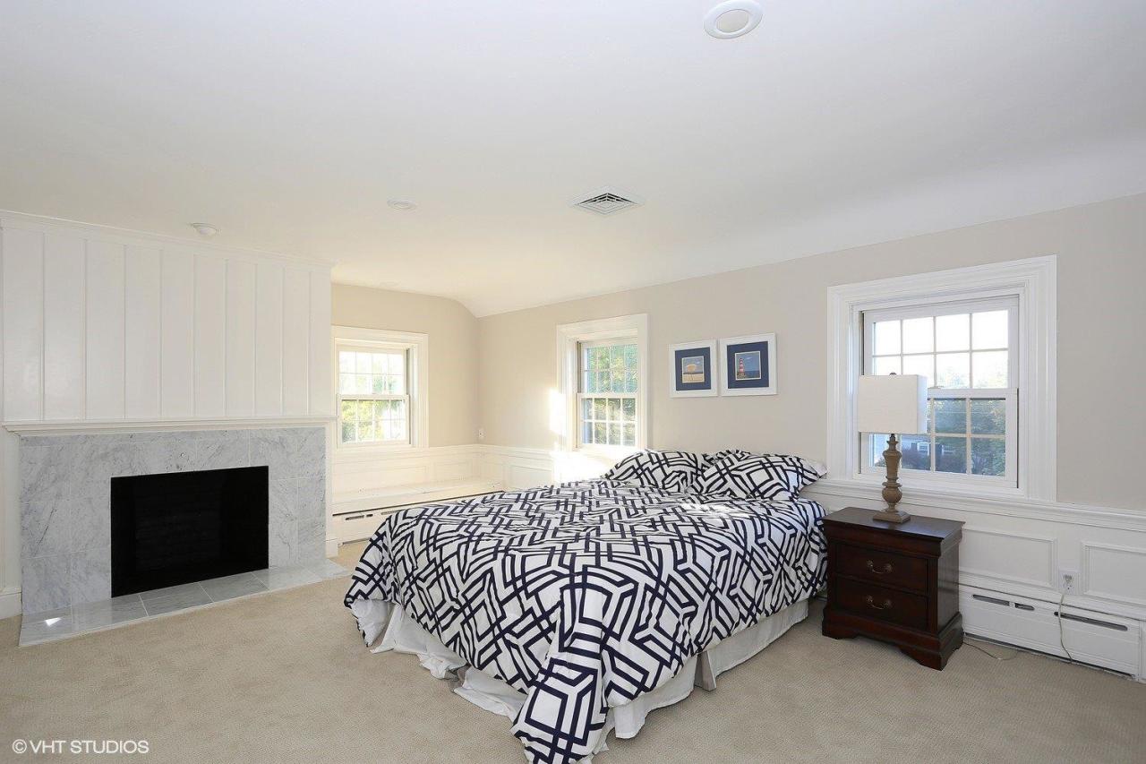 19 Salten Point Road Barnstable, MA 02630 - Photo 15 of 23 a bedroom with a bed and a fireplace