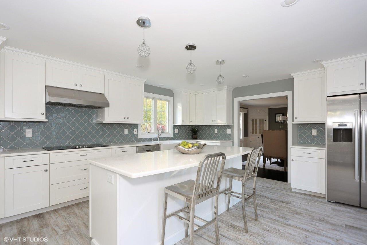 19 Salten Point Road Barnstable, MA 02630 - Photo 6 of 23 a kitchen with stainless steel appliances kitchen island granite countertop a table chairs refrigerator and cabinets