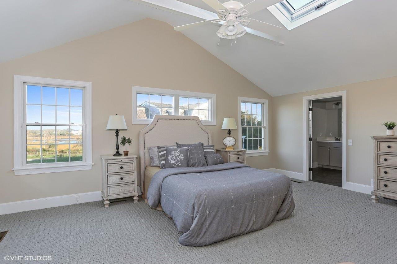 19 Salten Point Road Barnstable, MA 02630 - Photo 10 of 23 a bedroom with a bed and a chandelier