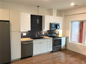 a kitchen with stainless steel appliances a stove refrigerator sink and microwave