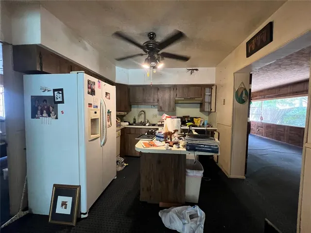 a living room with furniture a fireplace and a window