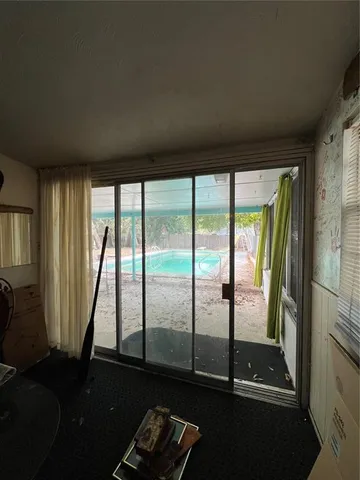 a view of a room with wooden floor and windows