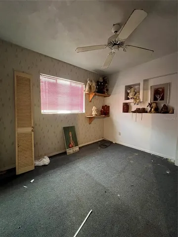 a view of a porch with furniture and a yard