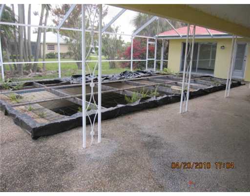 898 Southwest 15th Street Boca Raton, FL 33486 - Photo 14 of 16 a view of a house with a backyard