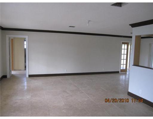 898 Southwest 15th Street Boca Raton, FL 33486 - Photo 2 of 16 an empty room with wooden floor and windows